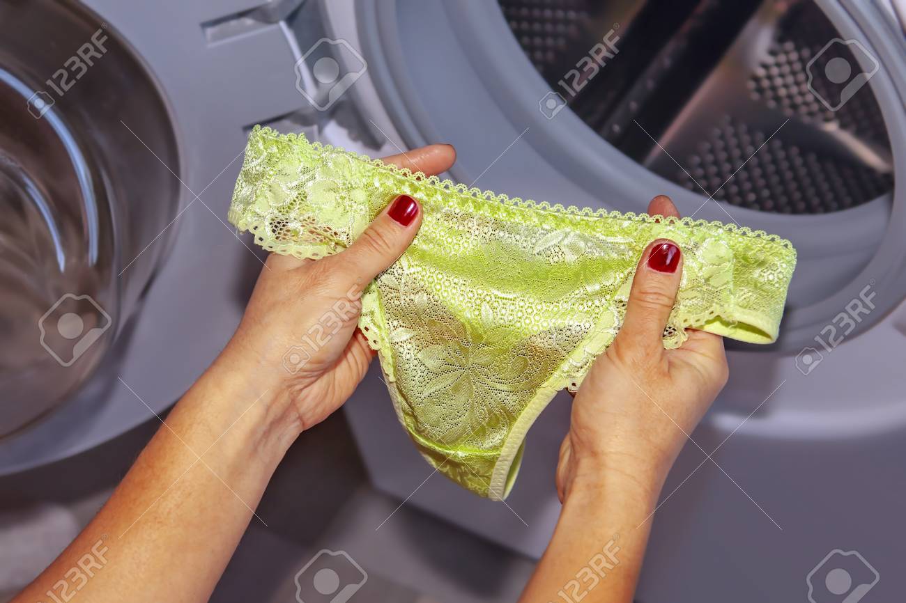 Stock Photo Womens Lace Panties In Hands Of Woman Who Is Going To Do Laundry It In Washing Machine Stock Photo Womens Lace Panties In Hands Of Woman Who Is Going To Do Laundry It In Washing Machine