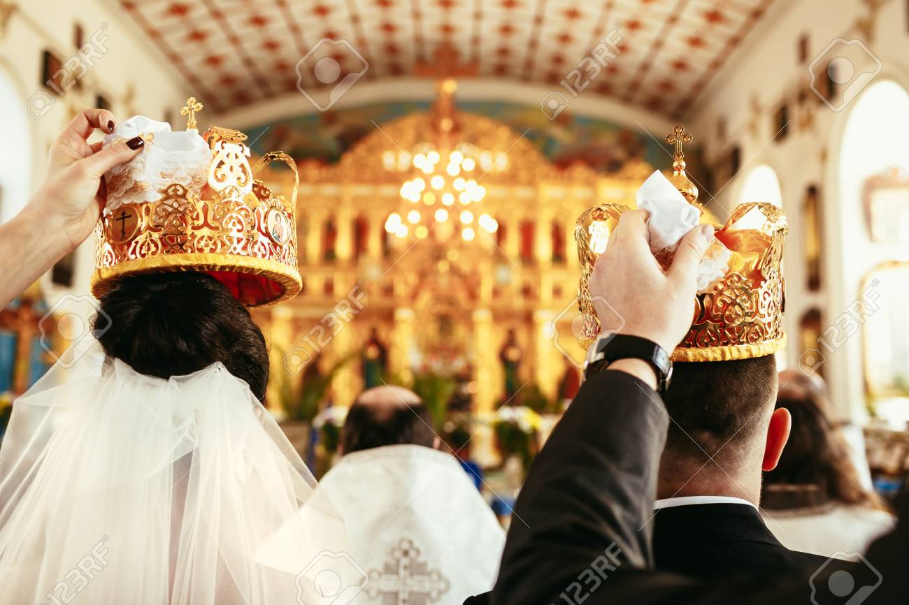 Wedding Ceremony Bride And Groom In The Orthodox Church. Witnesses Hold  Crowns Over The Heads Of The Newlyweds. Close-up, Back View Stock Photo,  Picture and Royalty Free Image. Image 83357936., image size:1300x866