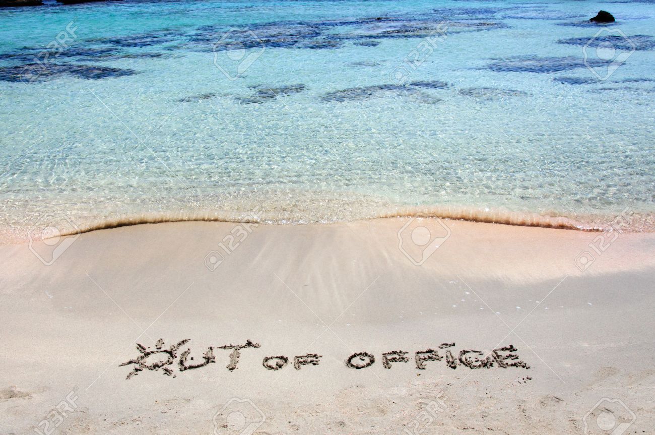 out of office written on sand on a beautiful beacout of office out of office