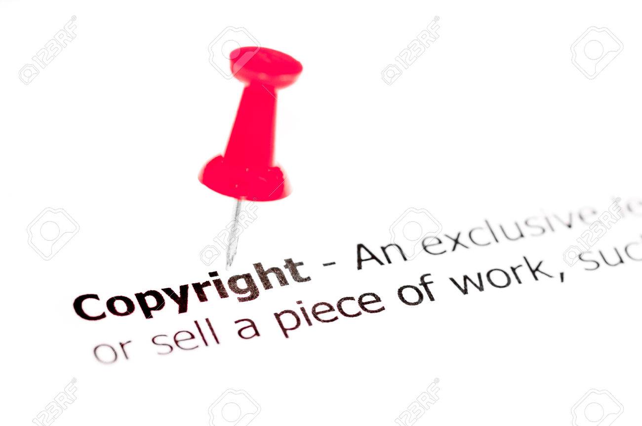 word copyright pinned on white paper with red pushpin available word red