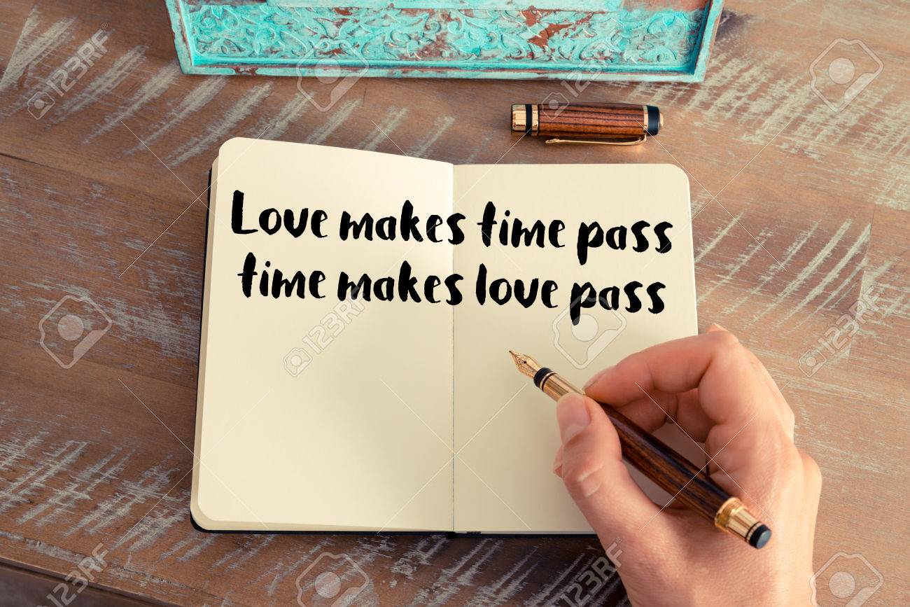 Handwritten quote Love makes time pass time makes love pass as inspirational concept image Stock