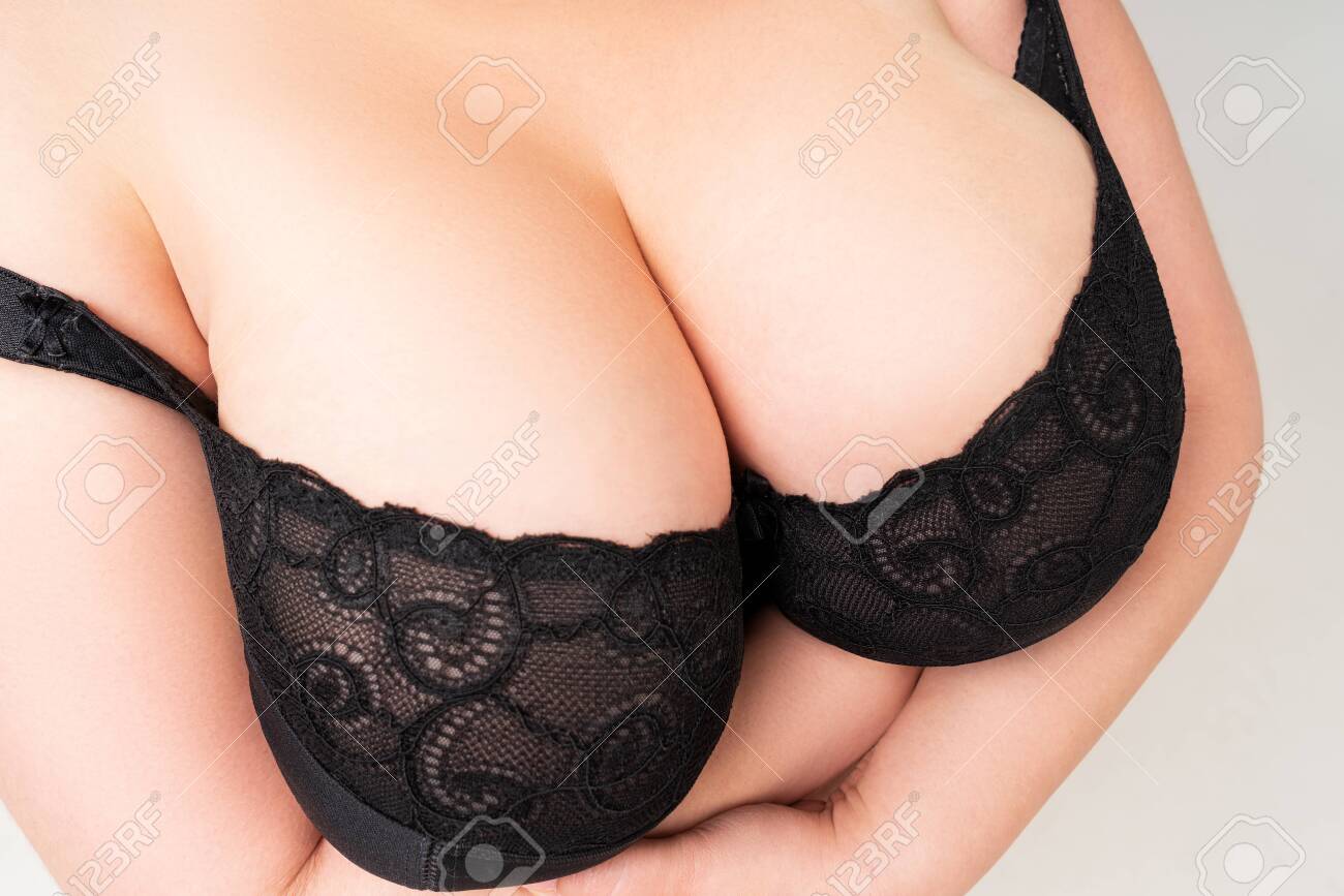 Big Natural Breasts In A Lace Bra Close-up, Biggest Boobs On Gray Background, Studio Shot Stock Photo, Picture and Royalty Free Image pic