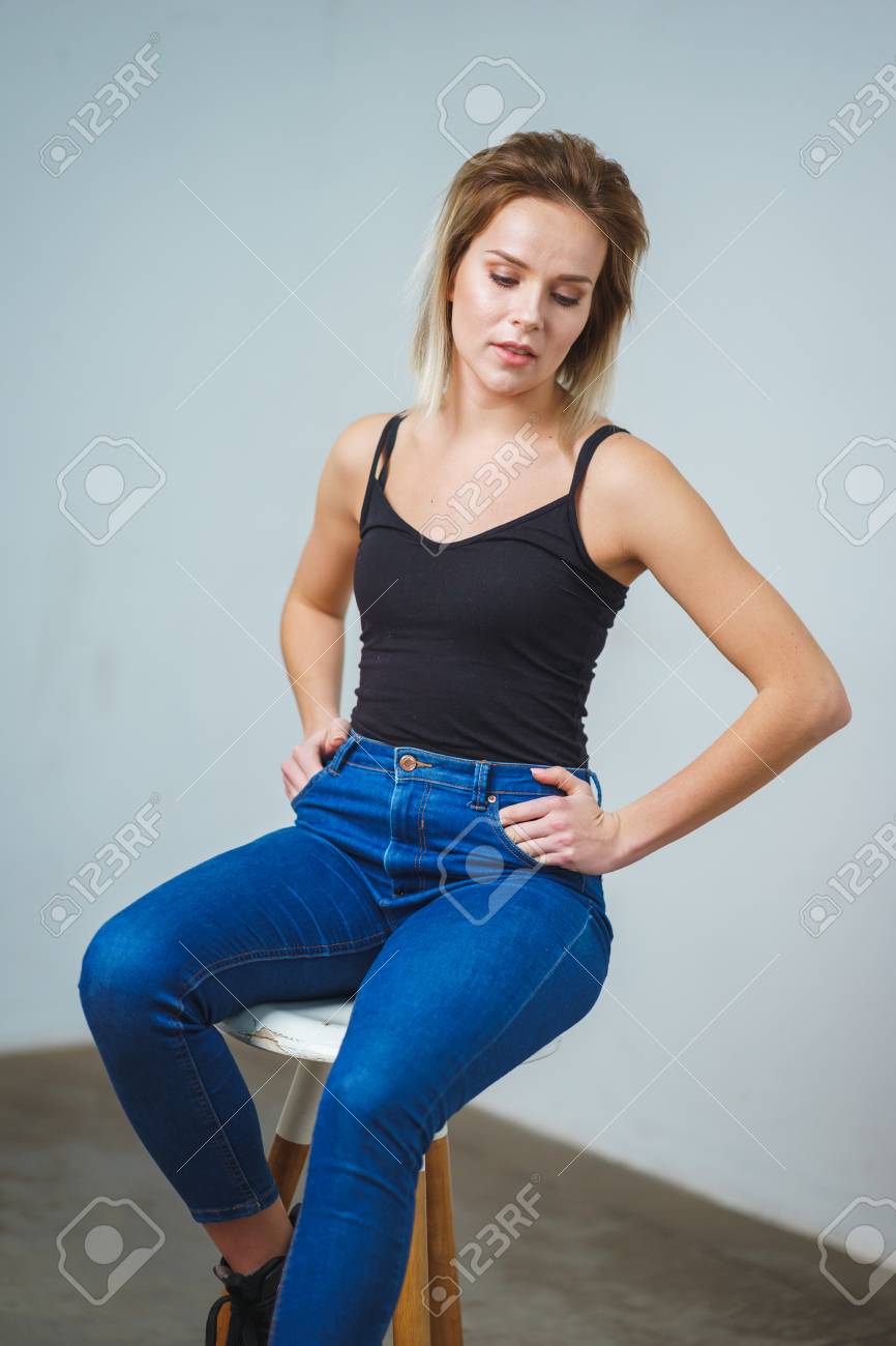 Model tests. Photo session model in studio. Simple attractive portraits for a young beautiful girl in an empty room. Snaps. Attractive girl in jeans, black shirt. Cheerful girl - 121662480 Model tests. Photo session model in studio. Simple attractive portraits for a young beautiful girl in an empty room. Snaps. Attractive girl in jeans, black shirt. Cheerful girl - 121662480