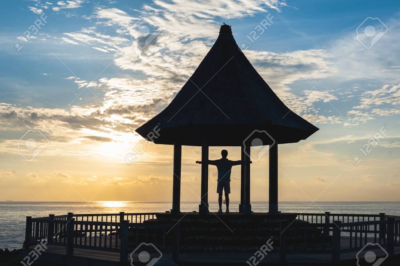 Man Greets World At Dawn Silhouette Of A Young Man A Traveler Stock Photo Picture And Royalty Free Image Image