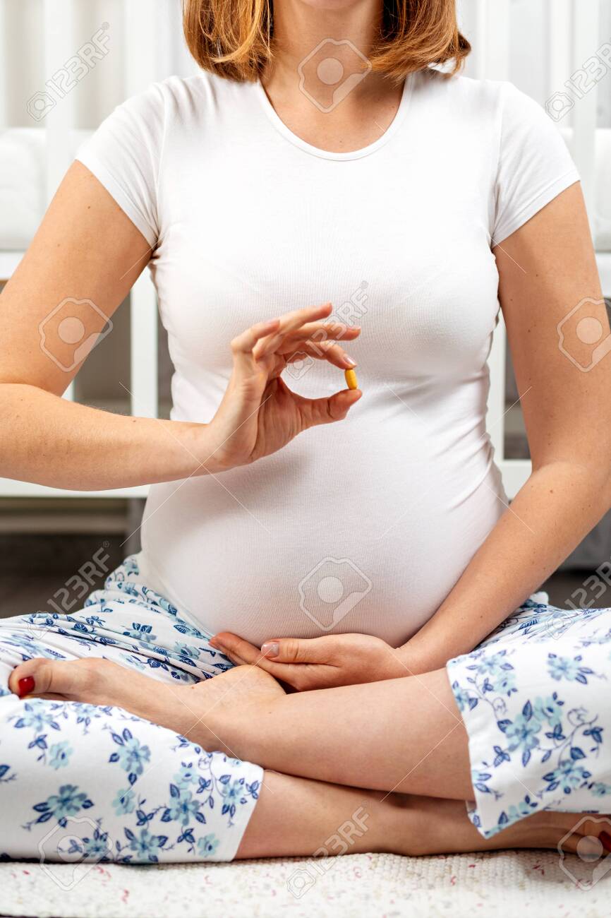 pics Sitting Cross Legged During Pregnancy a young pregnant woman is sitting cross legged on the floor
