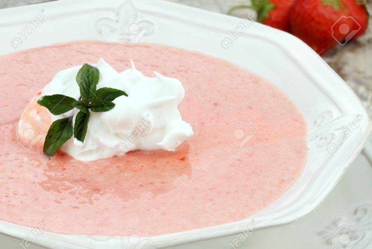 Macro of a bowl of chilled strawberry soup, garnished with a dollop of whipped cream and a fresh sprig of chocolate mint. Shallow depth of field with some blur on lower portion of image. - 9751451 Macro of a bowl of chilled strawberry soup, garnished with a dollop of whipped cream and a fresh sprig of chocolate mint. Shallow depth of field with some blur on lower portion of image. - 9751451