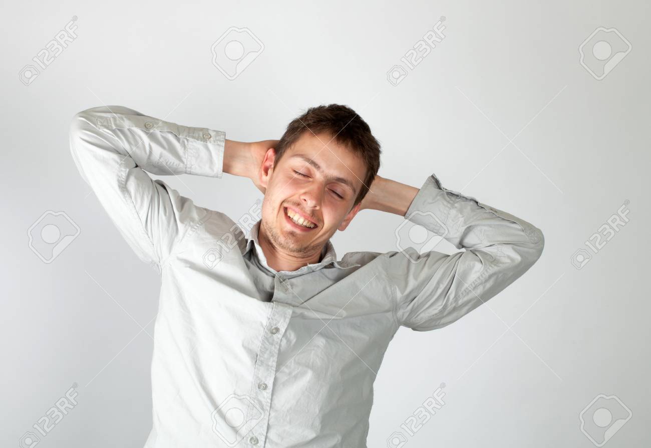 The guy in a light shirt has woken up recently. He stretches himself. A white background. - 9687703 The guy in a light shirt has woken up recently. He stretches himself. A white background. - 9687703
