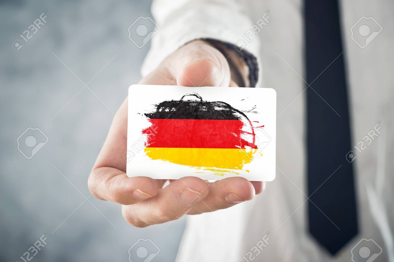 German Businessman holding business card with Germany Flag International cooperation, investments, business opportunities concept - 25887345 German Businessman holding business card with Germany Flag International cooperation, investments, business opportunities concept - 25887345