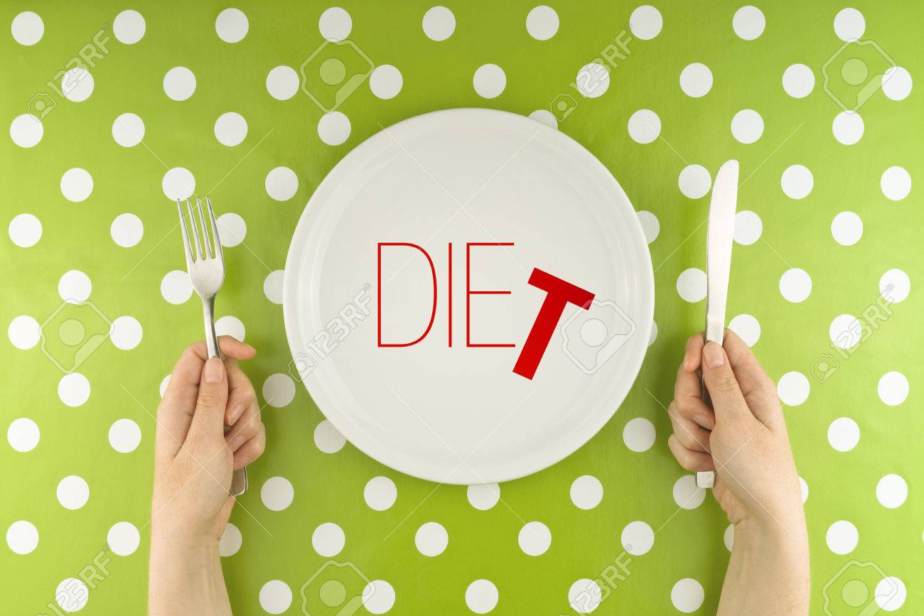 Female hands at dinner table holding fork and a knife above plate - 30792453 Female hands at dinner table holding fork and a knife above plate - 30792453