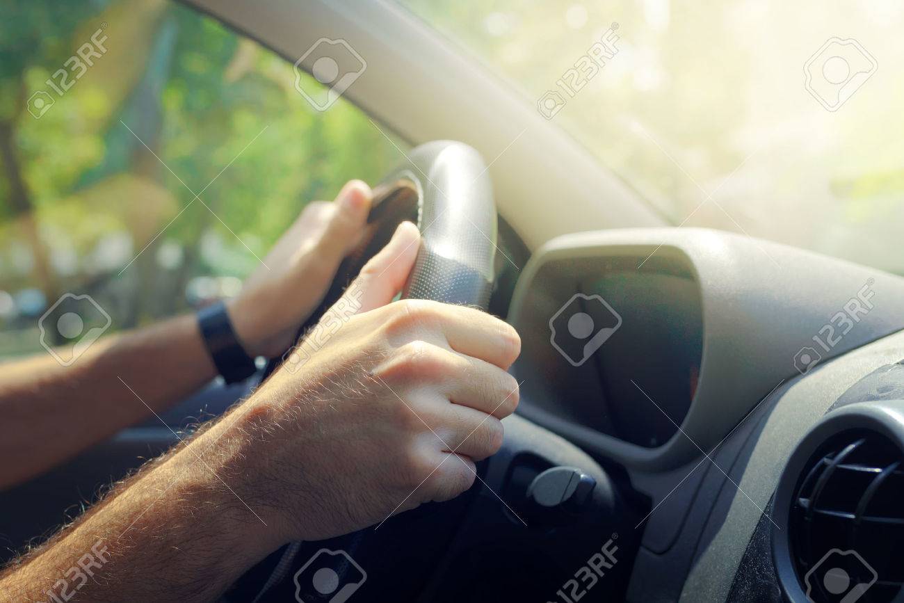 Male hands holding car steering wheel the right way for safe driving - 62392410 Male hands holding car steering wheel the right way for safe driving - 62392410