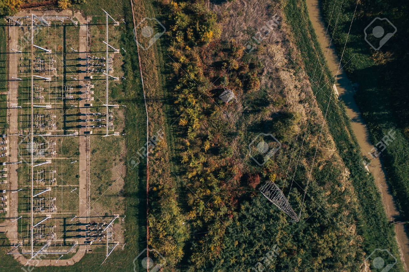 Aerial view of electricity power substation plant and pylons in the field, top view of industrial infrastructure from drone pov. - 89019952 Aerial view of electricity power substation plant and pylons in the field, top view of industrial infrastructure from drone pov. - 89019952