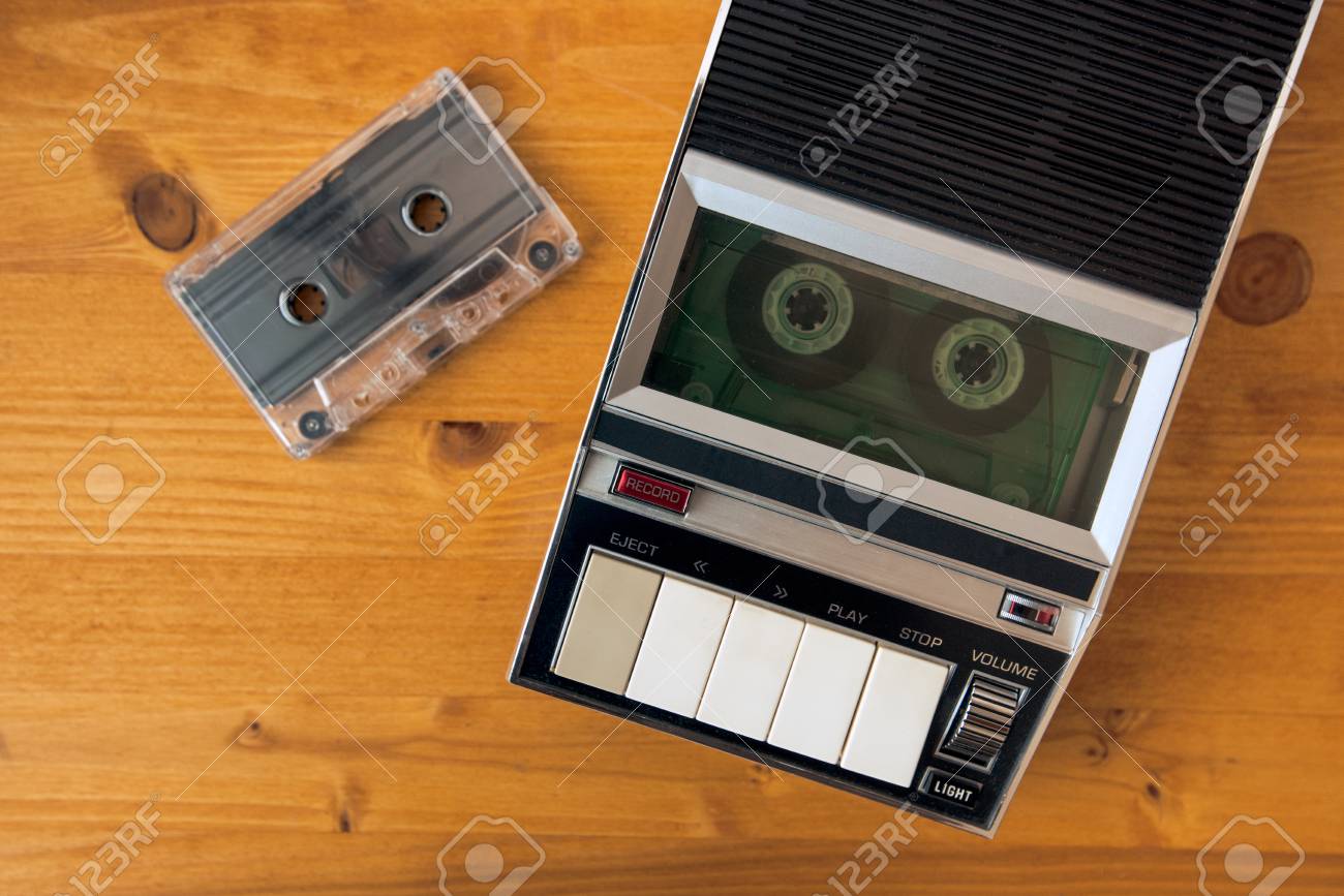 audio cassette tape rolling in vintage player on the desk top