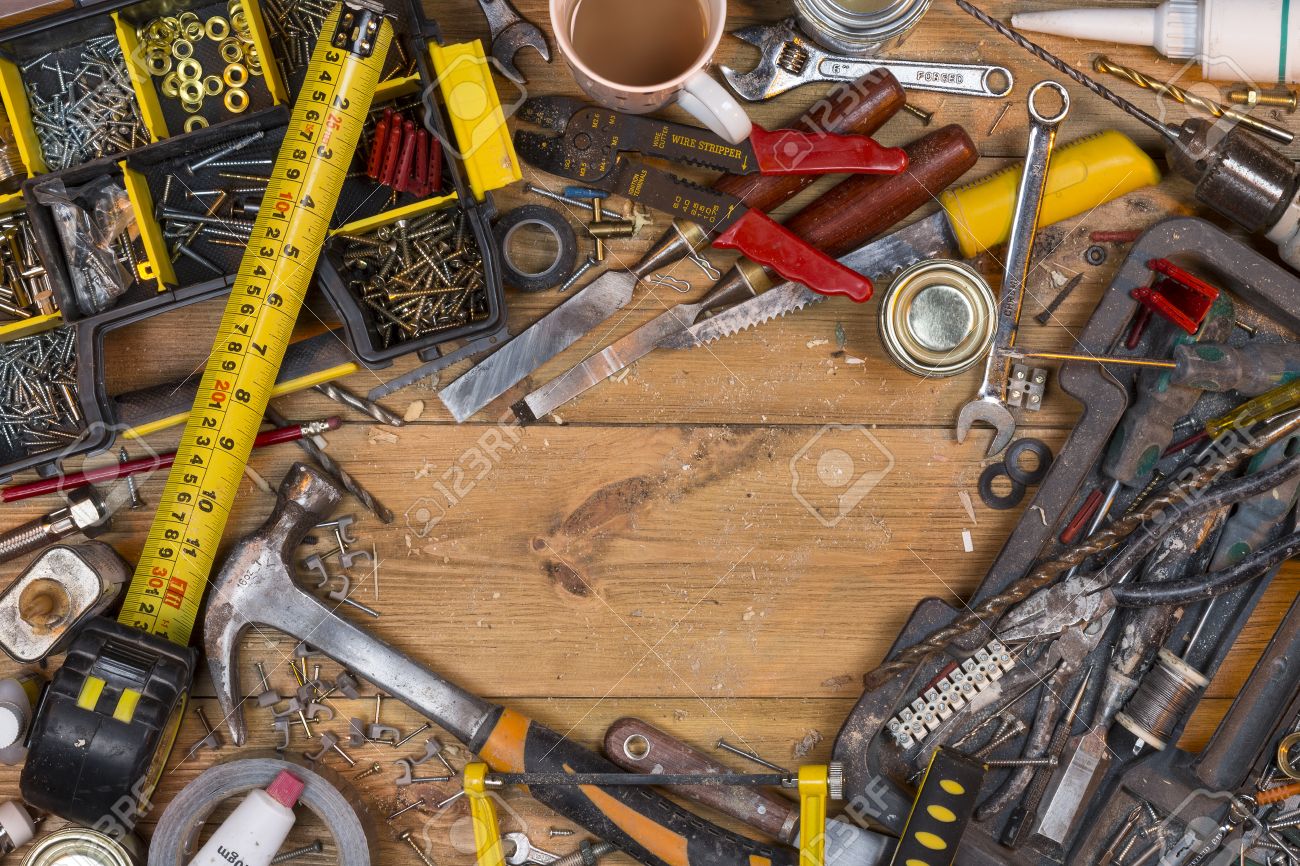 Home maintenance - An untidy workbench full of dusty old tools and screws with space for text. - 40881135 Home maintenance - An untidy workbench full of dusty old tools and screws with space for text. - 40881135