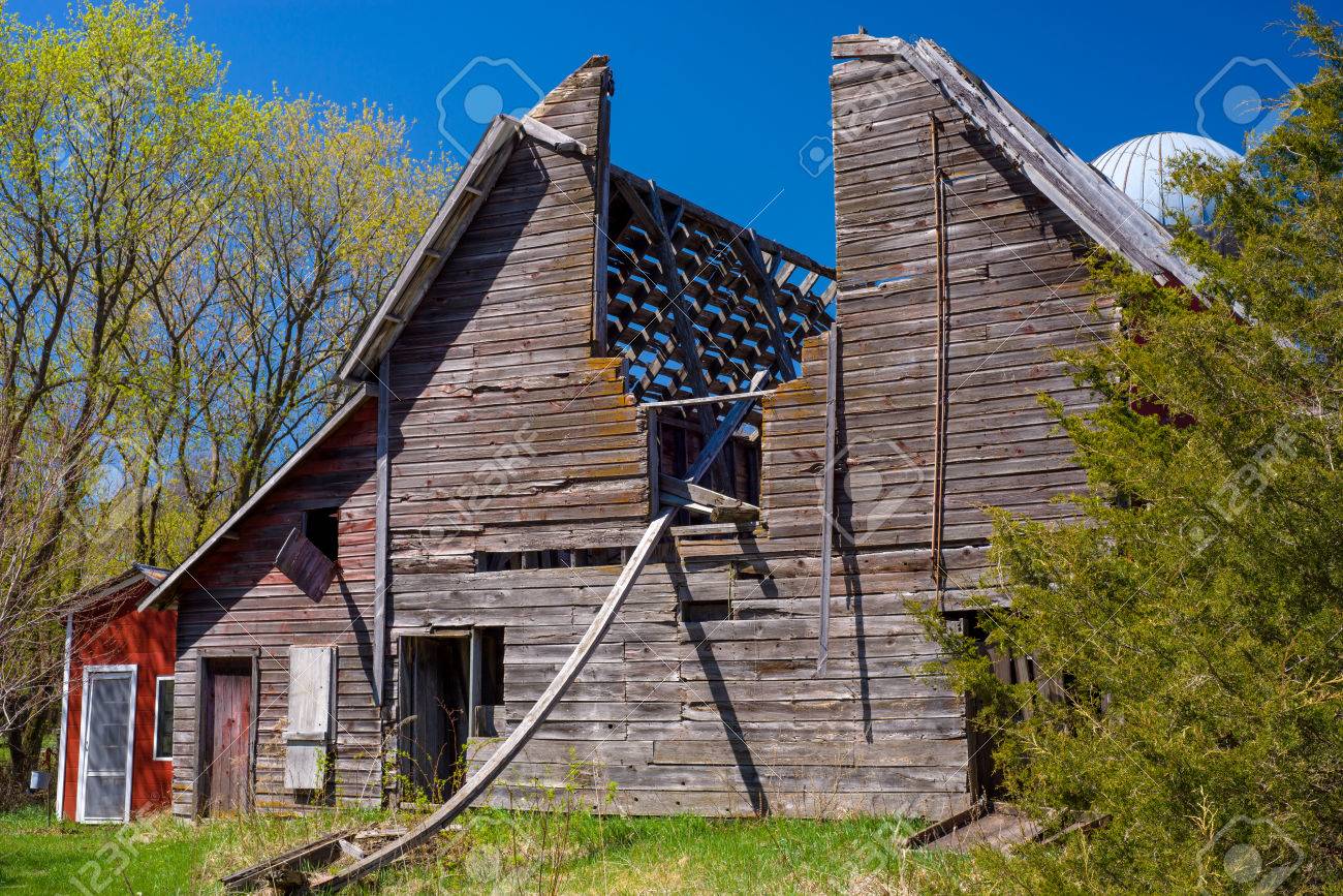 an old weathered barn has fallen into disrepair creating a skylight