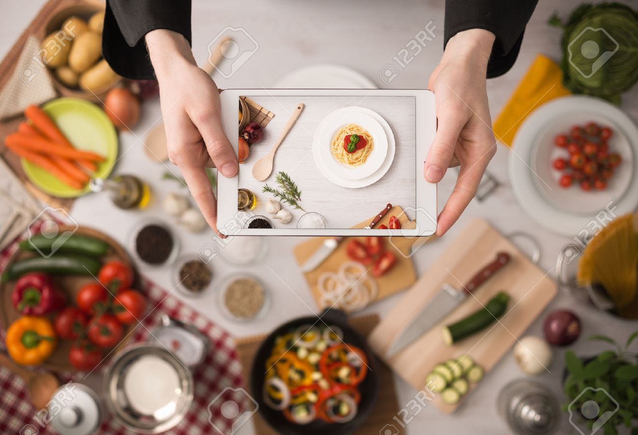 Kitchen Table Close Up cook's hands holding a touch screen tablet close up, kitchen Kitchen Table Close Up cook's hands holding a touch screen tablet close up, kitchen