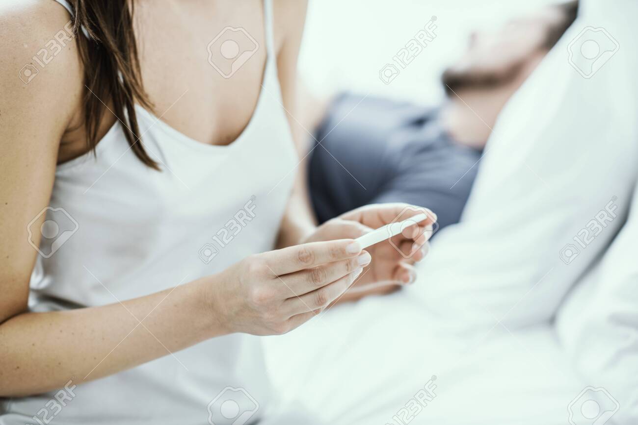 Young Woman Sitting On The Bed And Waiting For Pregnancy Test Stock Photo Picture And Royalty Free Image Image 145889758