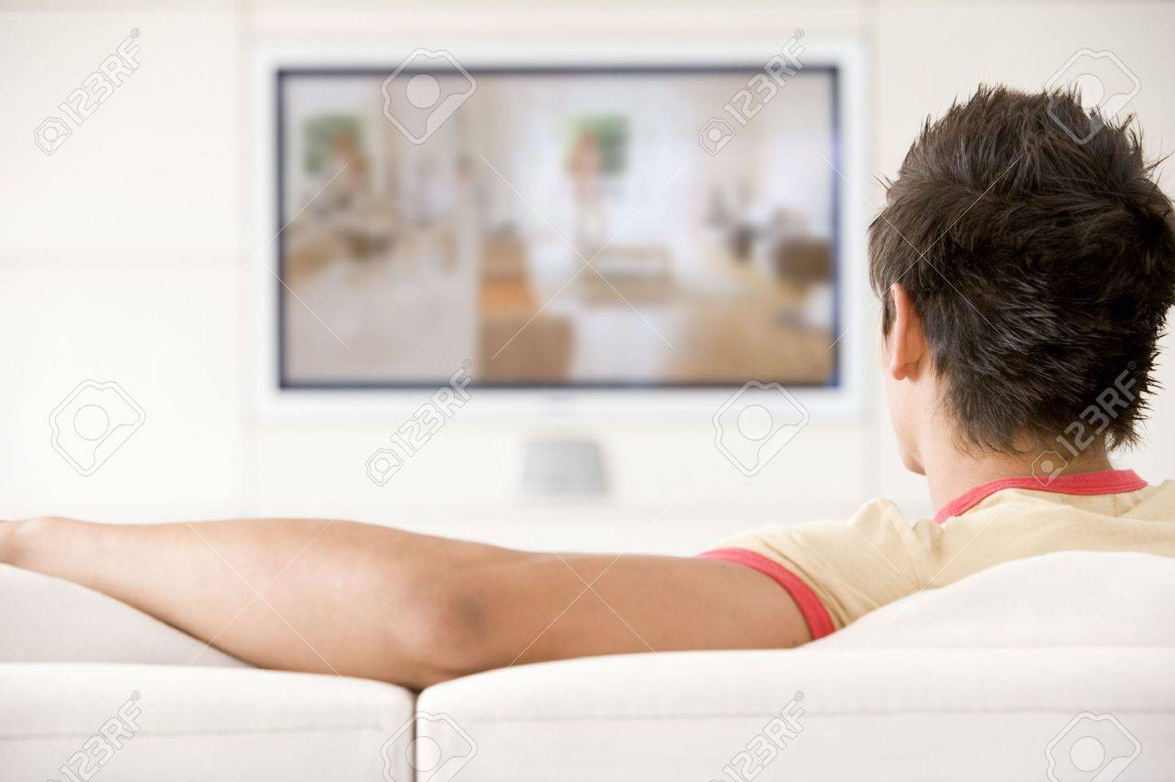 Man in living room watching television - 3456320 Man in living room watching television - 3456320