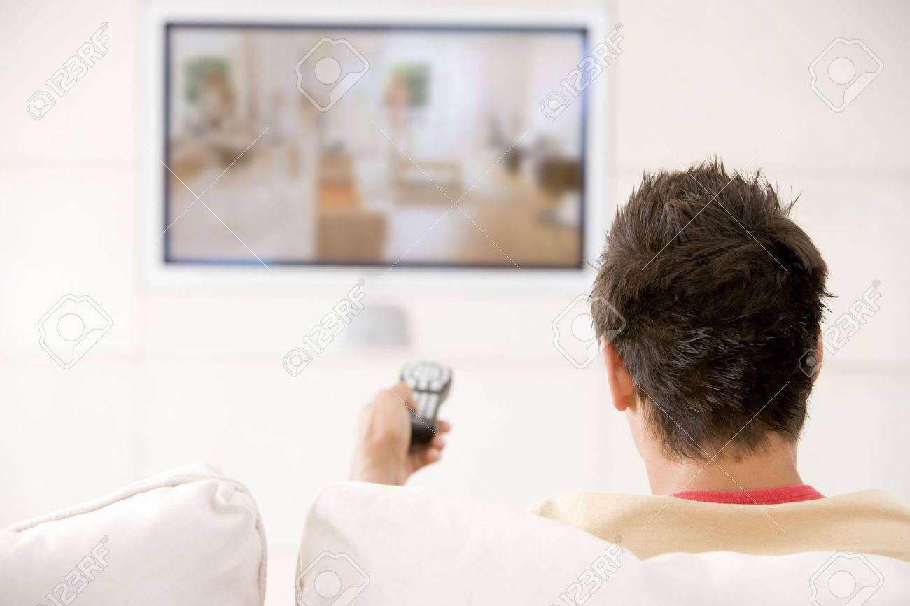 Man in living room watching television - 3482443 Man in living room watching television - 3482443