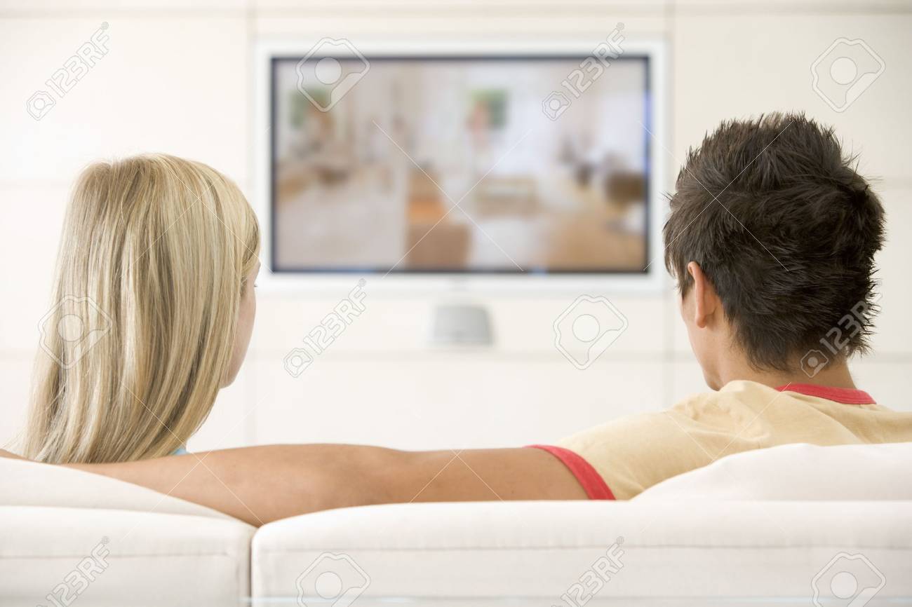 Couple in living room watching television - 3482674 Couple in living room watching television - 3482674