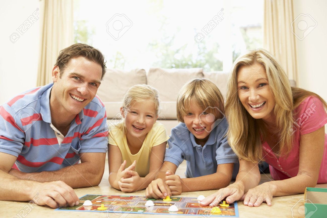 Family Playing Board Game At Home Stock Photo Family Playing Board Game At Home Stock Photo