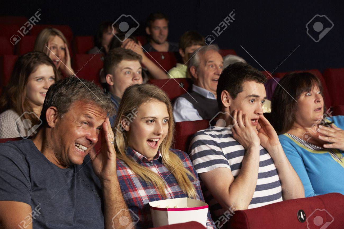 Teenage Family Watching Film In Cinema Stock Photo Picture And