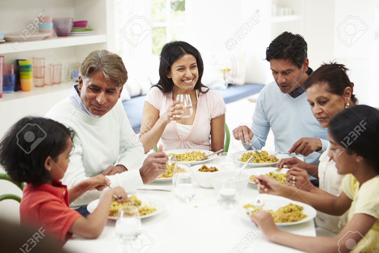 Multi Generation Indian Family Eating Meal At Home - 24508165 Multi Generation Indian Family Eating Meal At Home - 24508165
