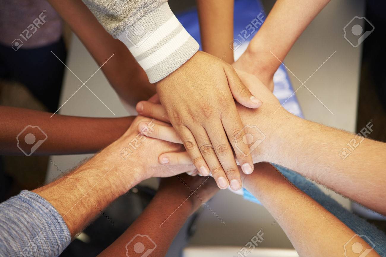 hands from young people of different races joined together stock