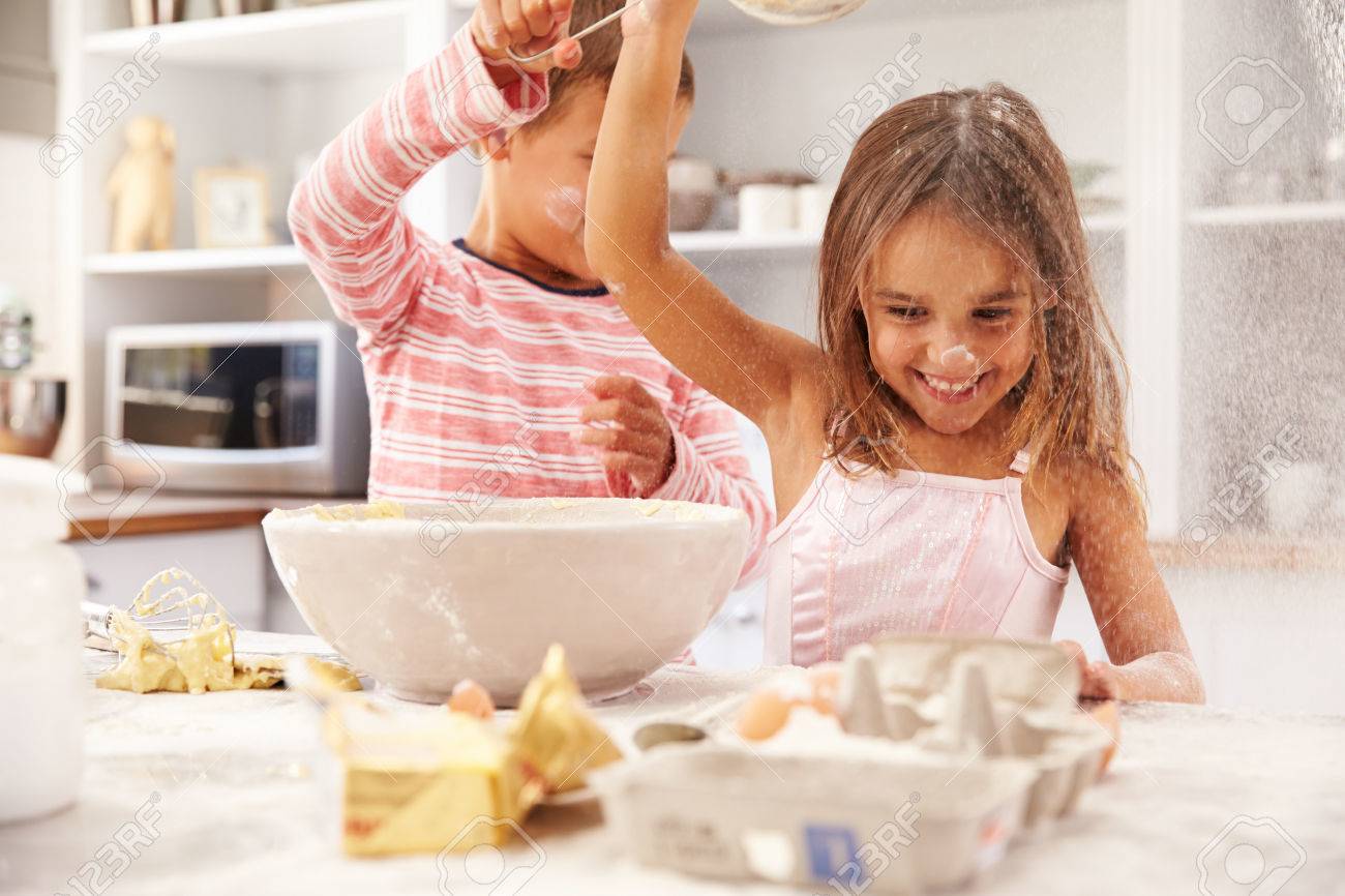 Two children having fun baking in the kitchen - 41393318 Two children having fun baking in the kitchen - 41393318