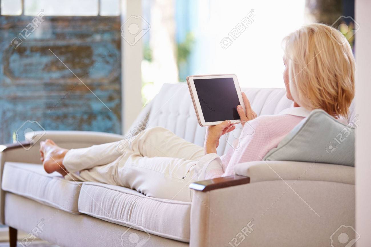 熟女主婦家庭内画像 熟女デジタル タブレットを使用して自宅でソファーでリラックスの写真素材・画像素材 Image 41393356