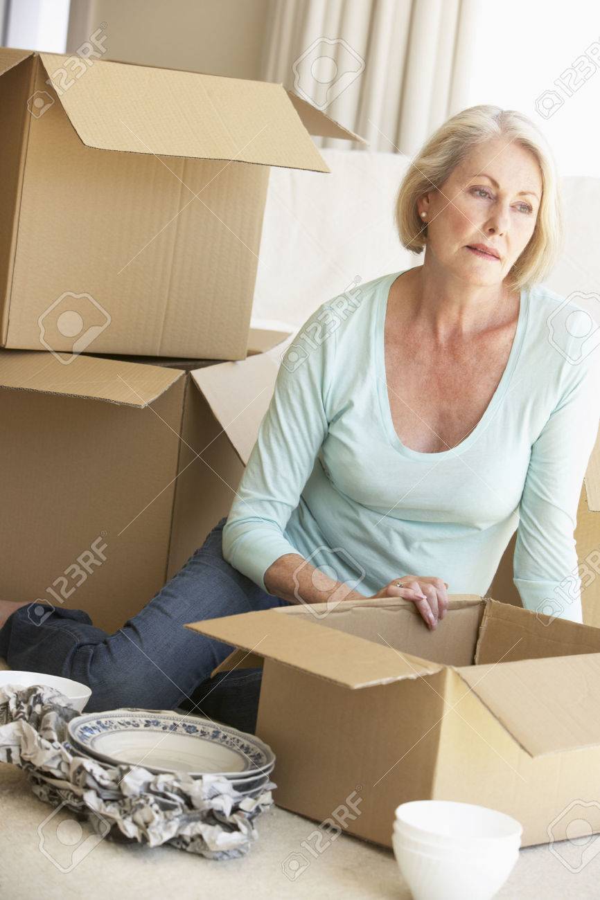 senior woman moving home and packing boxes stock photo picture and