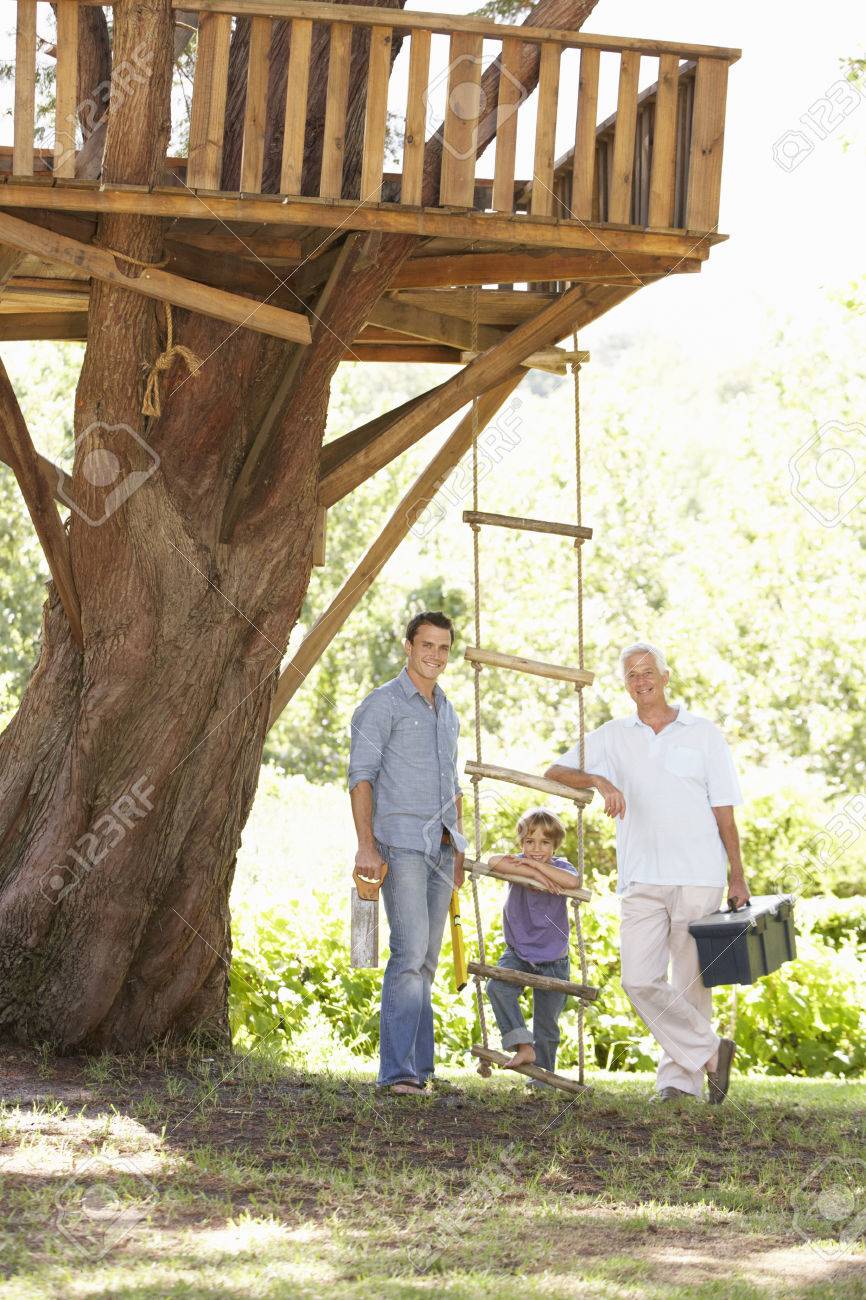 Grandfather Father And Son Building Tree House Together Stock