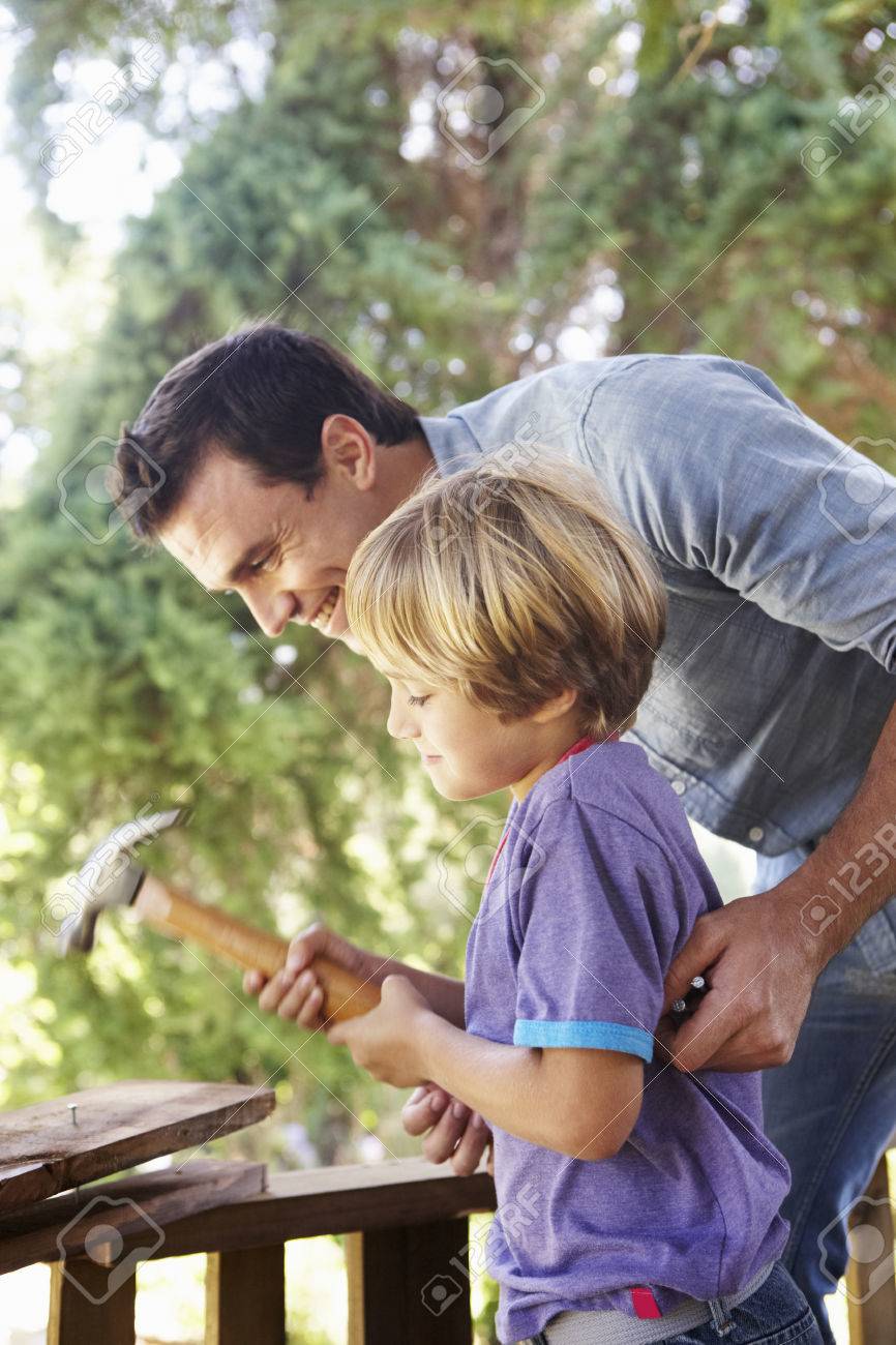 Father And Son Building Tree House Together Stock Photo Picture