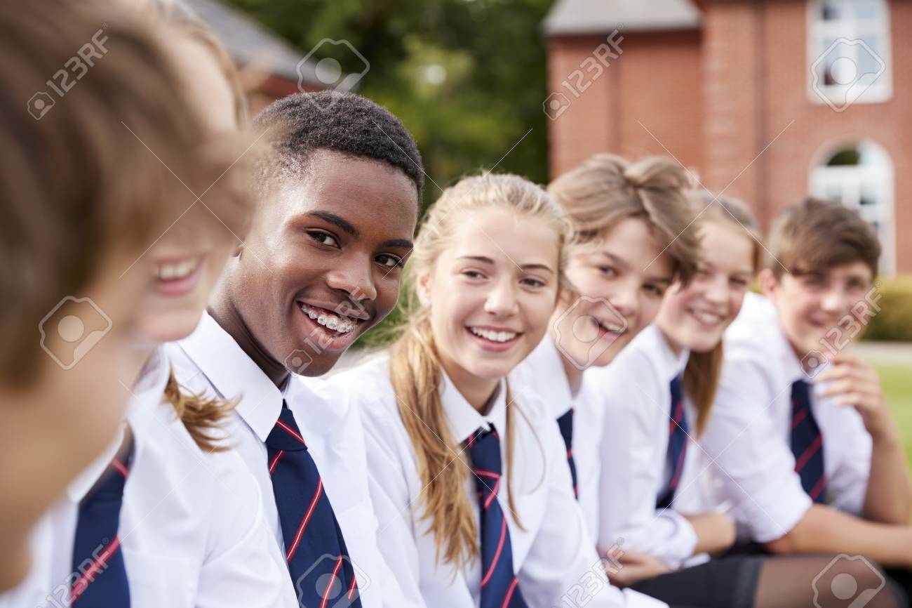 Group Of Teenage Students In Uniform Outside School Buildings - 91650586 Group Of Teenage Students In Uniform Outside School Buildings - 91650586
