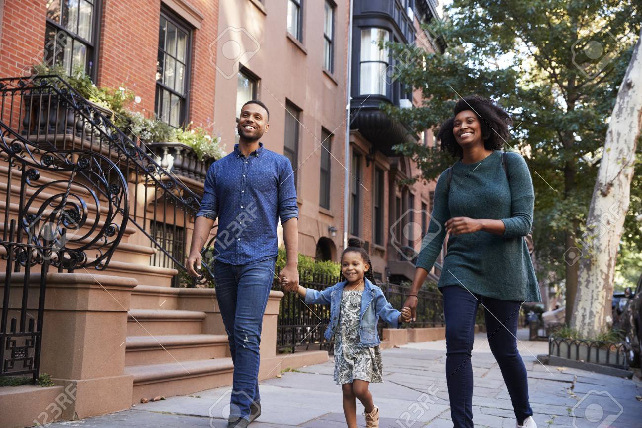 Family Taking A Walk Down The Street, Close Up Stock Photo, Picture and  Royalty Free Image. Image 92735125., image size:1300x866