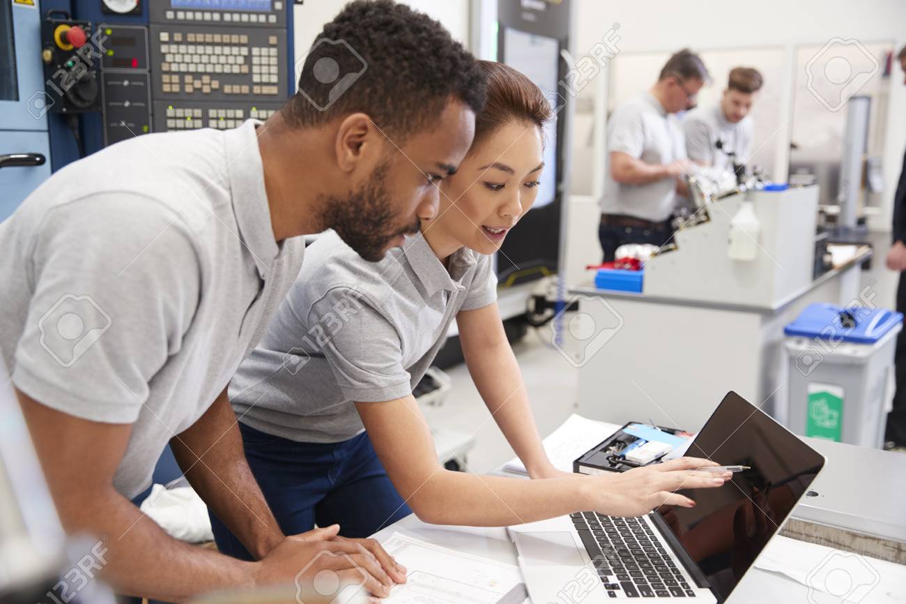 Two Engineers Using CAD Programming Software On Laptop - 99606875 Two Engineers Using CAD Programming Software On Laptop - 99606875