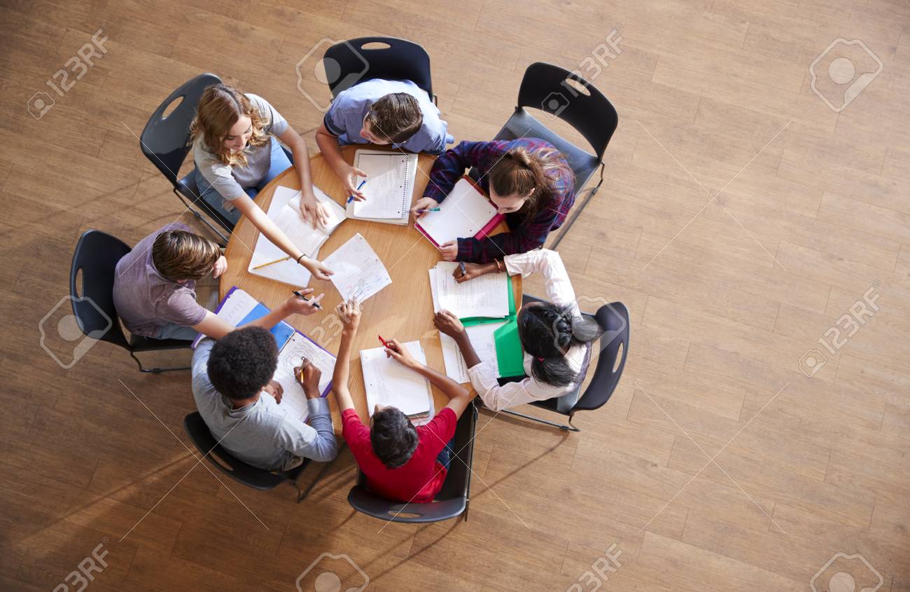 Overhead Shot Of High School Pupils In Group Study Around Tables - 104017662 Overhead Shot Of High School Pupils In Group Study Around Tables - 104017662