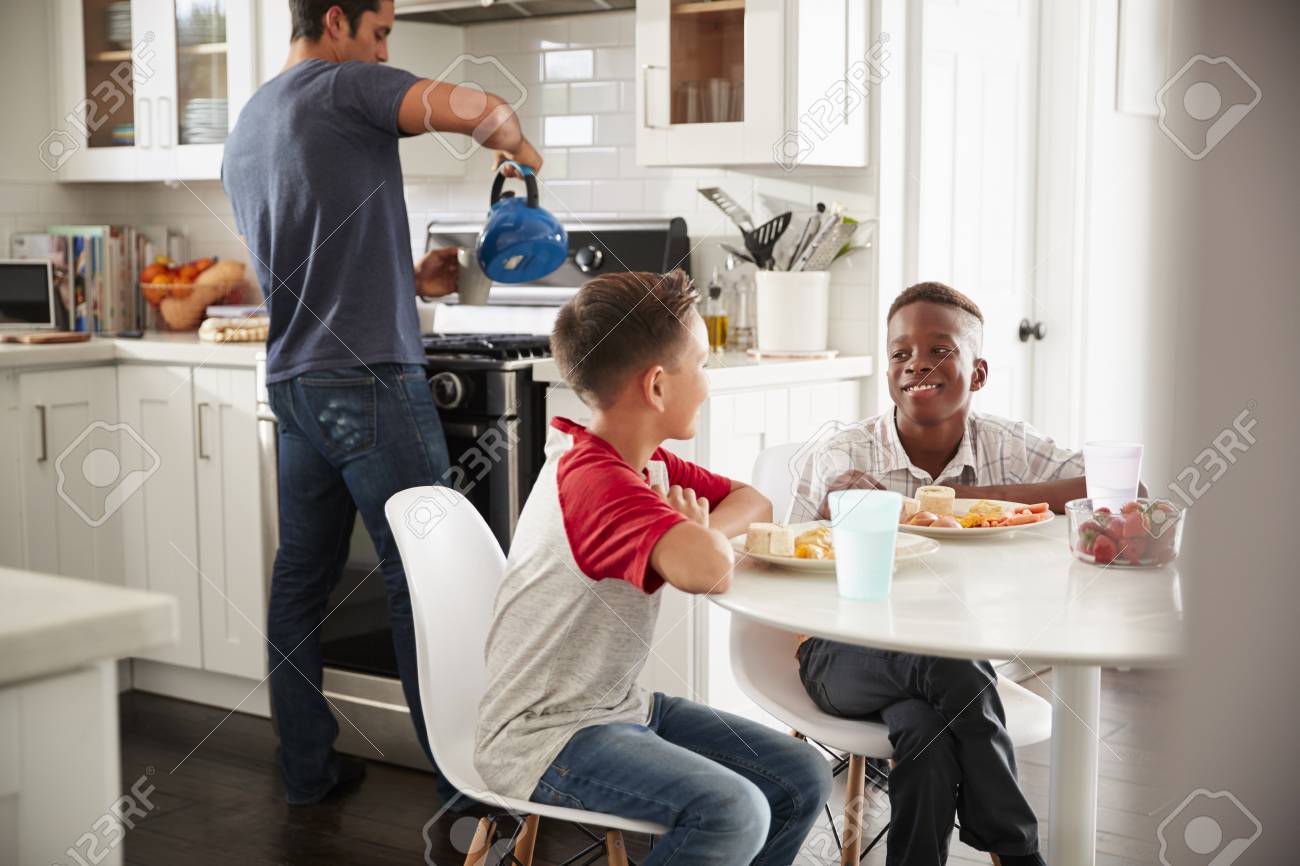 Two Pre Teen Male Friends Sit Talking In Kitchen At One Boy S Stock Photo Picture And Royalty Free Image Image 115389327