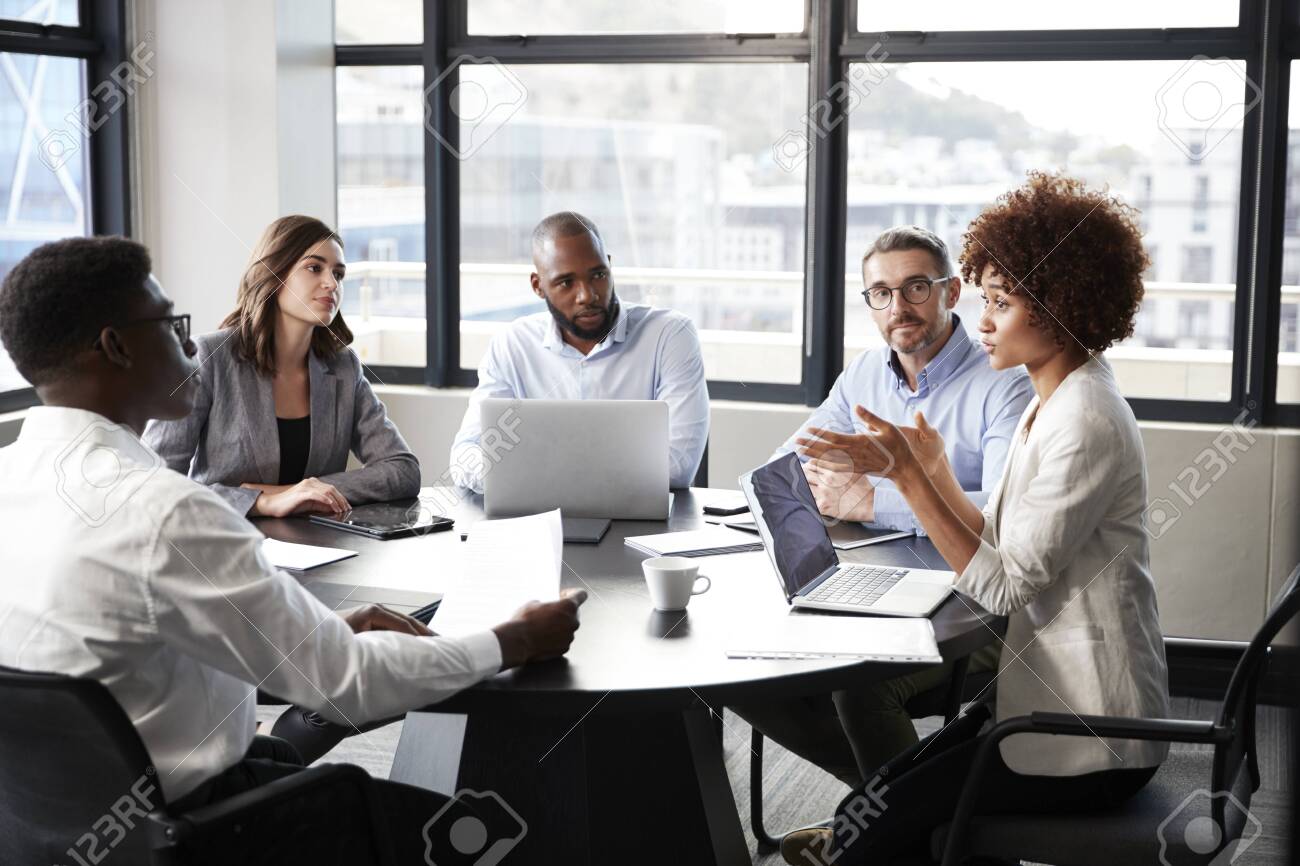 Millennial black businesswoman addressing colleagues at a corporate business meeting, close up - 122610121 Millennial black businesswoman addressing colleagues at a corporate business meeting, close up - 122610121