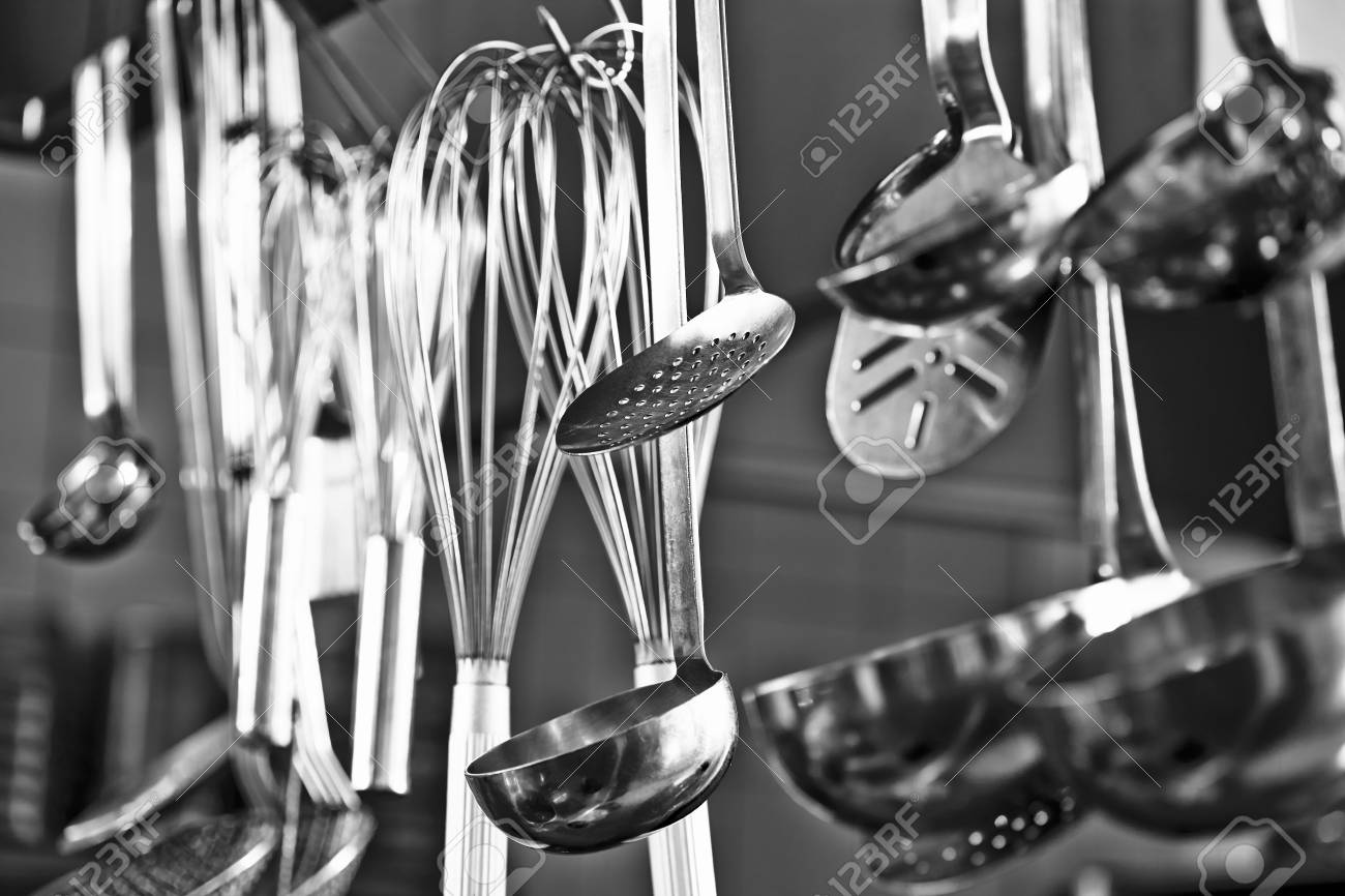 Restaurant Kitchen Utensils cooking utensils hanging in a restaurant kitchen stock photo Restaurant Kitchen Utensils cooking utensils hanging in a restaurant kitchen stock photo
