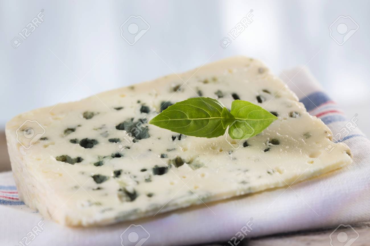 a slice of roquefort marival french blue cheese stock photo