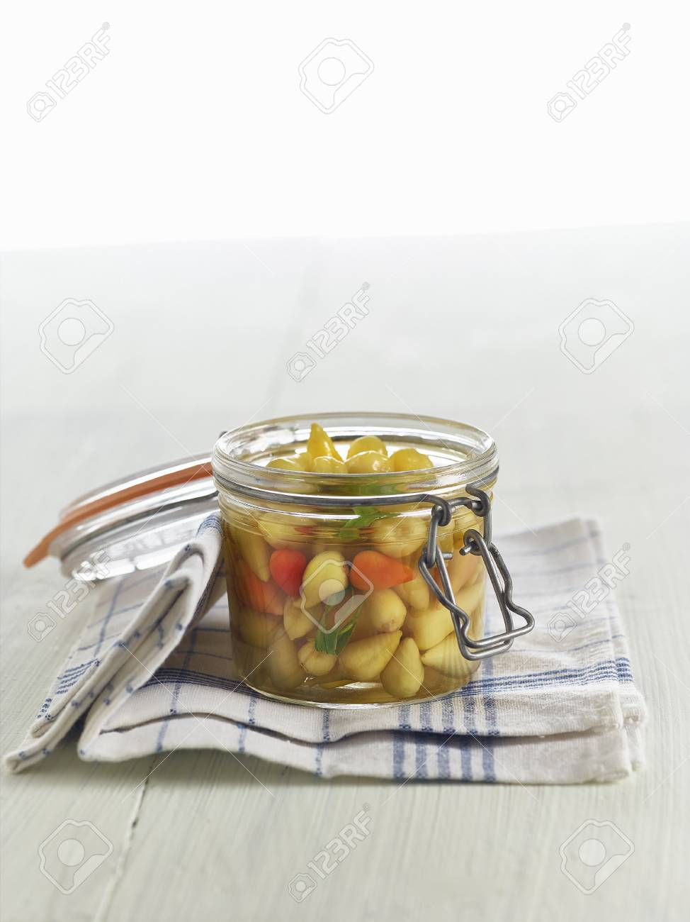 lacto fermented mini peppers with tarragon in a mason jar stock