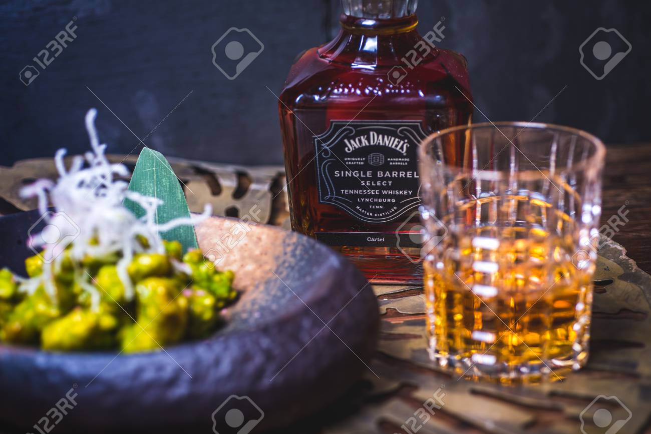 A bottle of alcohol is in the background. - 99534749 A bottle of alcohol is in the background. - 99534749
