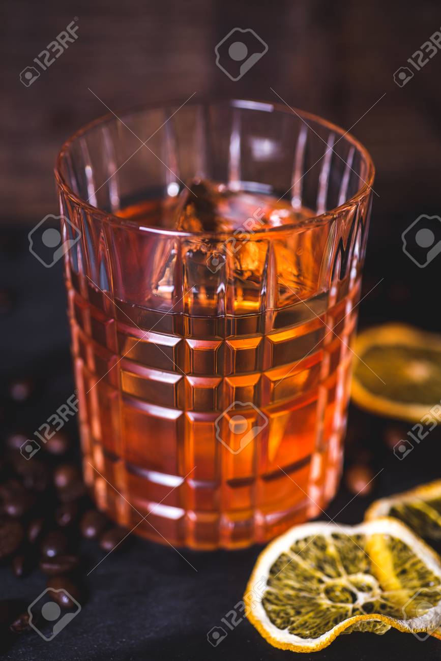 An ice cube floats in alcohol in a glass. - 99538273 An ice cube floats in alcohol in a glass. - 99538273