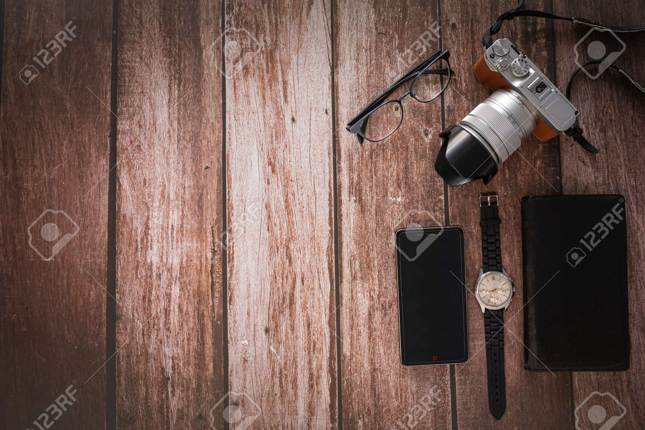 Overhead view of Traveler's accessories on wooden table background with Photo camera, Smart phone, Glasses with copy space. traveling concept background. Flat lay. - 163135782 Overhead view of Traveler's accessories on wooden table background with Photo camera, Smart phone, Glasses with copy space. traveling concept background. Flat lay. - 163135782