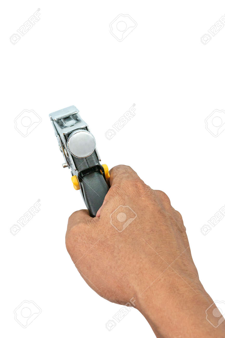 A male hand holds a construction stapler on a white background. Heavy-duty steel staple gun to repairs or DIY around your home. Selective focus. - 163135787 A male hand holds a construction stapler on a white background. Heavy-duty steel staple gun to repairs or DIY around your home. Selective focus. - 163135787
