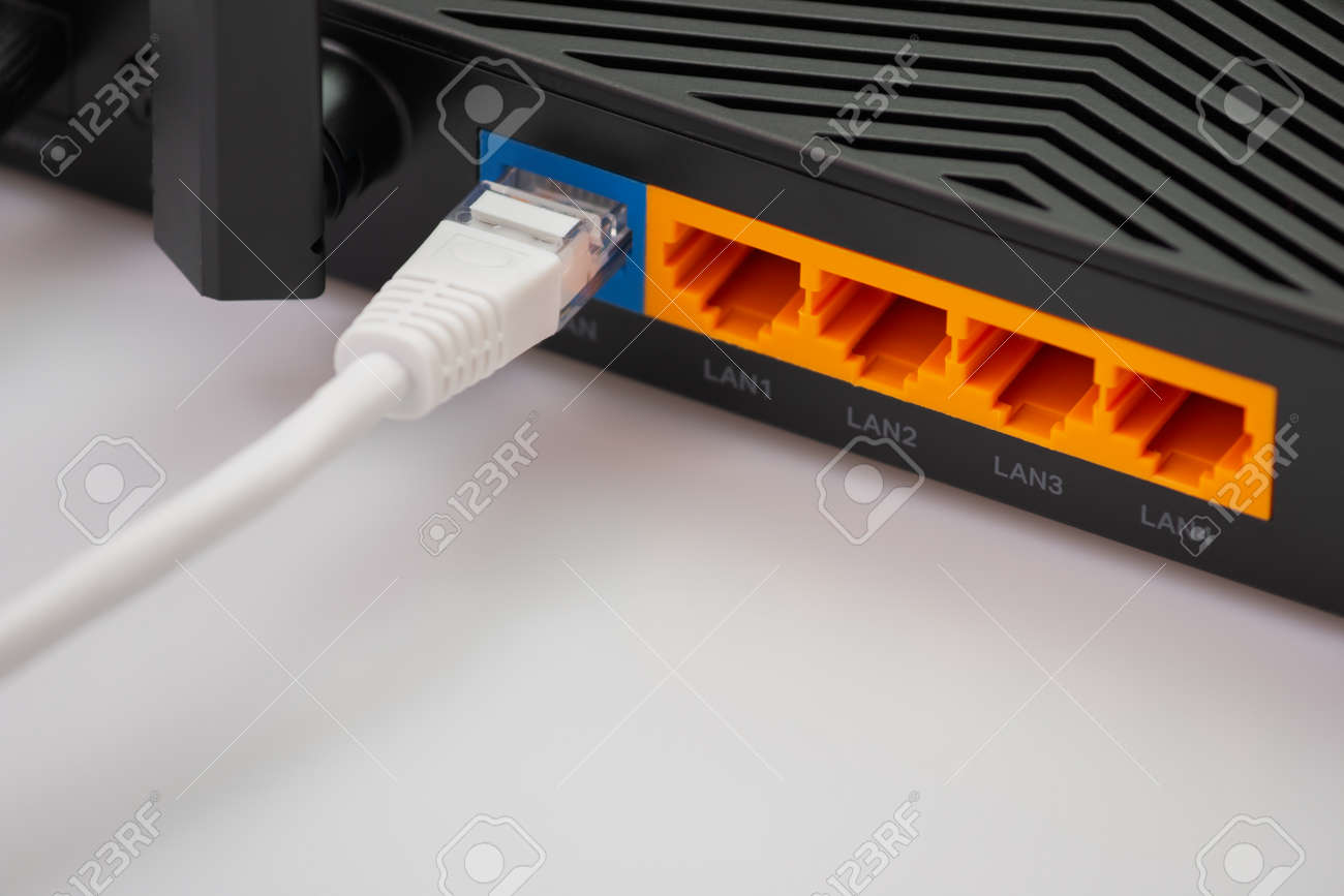 Wireless internet router with connected cables, The backside of fiber optic internet, and network cables connected to a router. Internet security and hi-speed concept. Selective focus. Close-up - 166001332 Wireless internet router with connected cables, The backside of fiber optic internet, and network cables connected to a router. Internet security and hi-speed concept. Selective focus. Close-up - 166001332