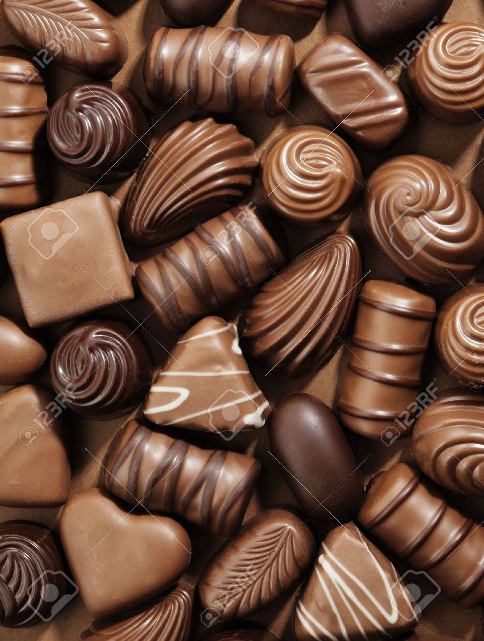 Assorted Chocolate Pralines On Brown Background Stock Photo Picture