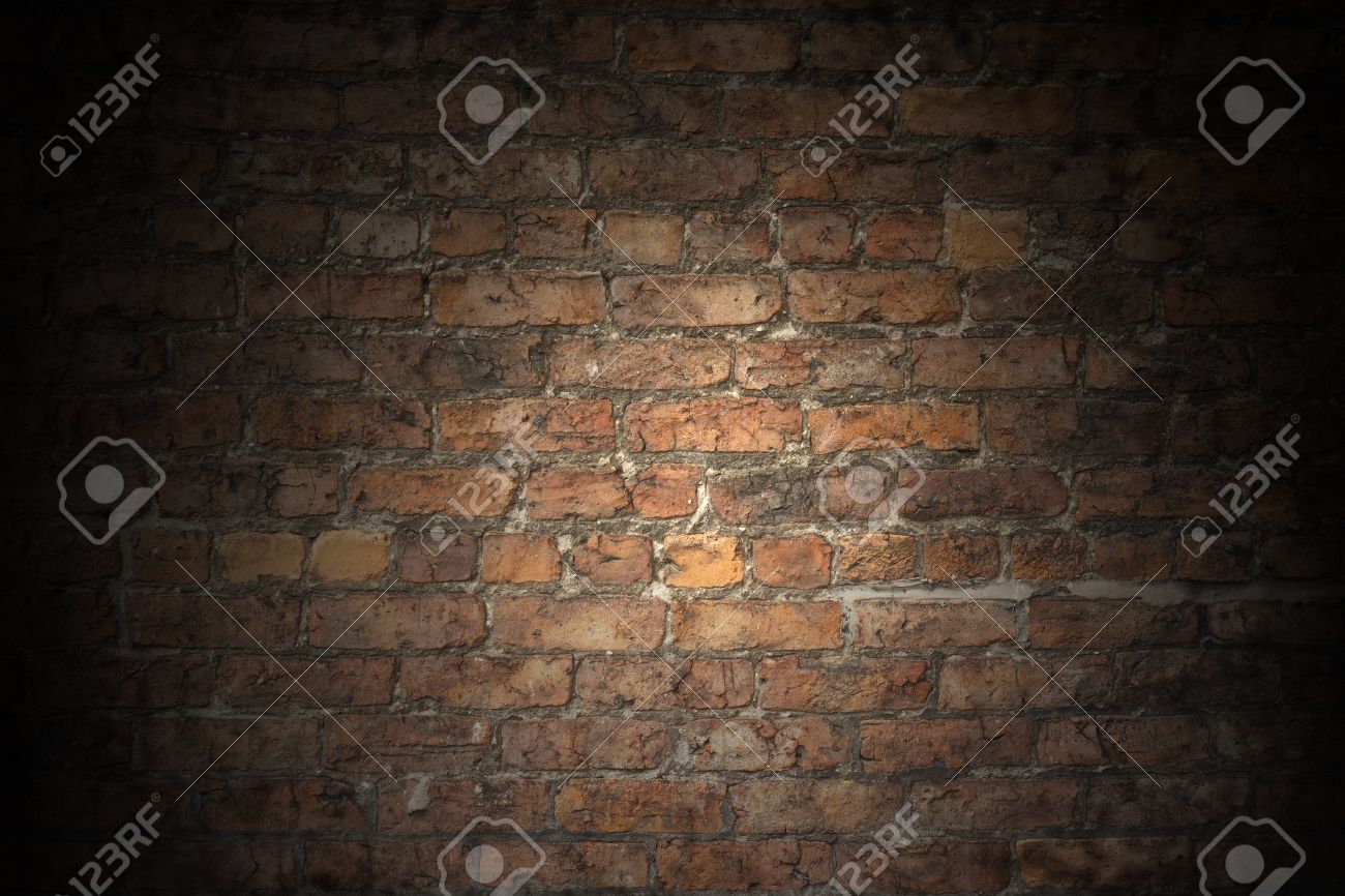 a plain red brick wall old and worn with grey aged grouting stock