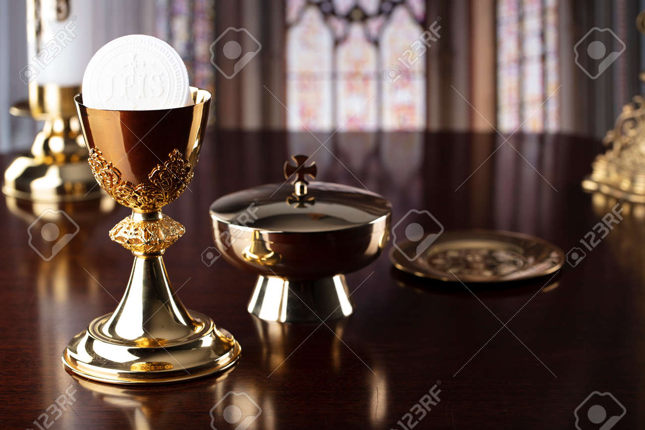 First Holy Communion. Catholic religion theme. Crucifix, the Croass and Golden chalice and wafer on the altar. - 168772311 First Holy Communion. Catholic religion theme. Crucifix, the Croass and Golden chalice and wafer on the altar. - 168772311