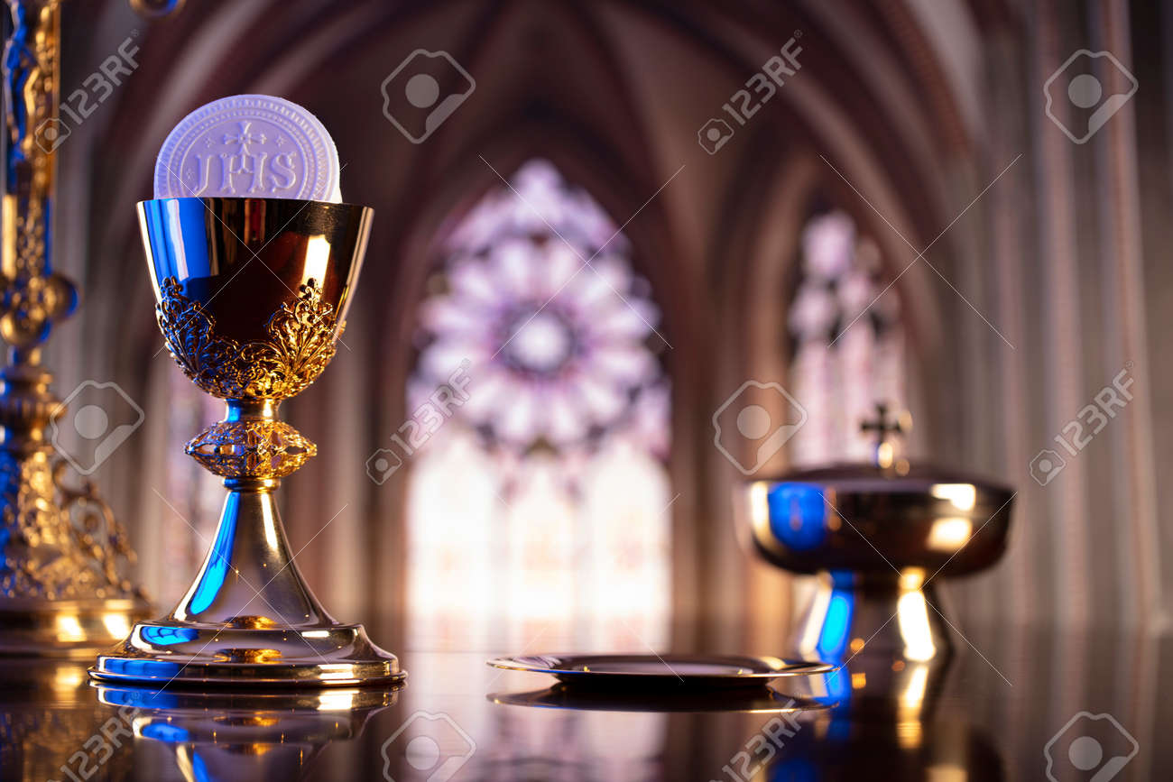 First Holy Communion. Catholic religion theme. Crucifix, the Croass and Golden chalice and wafer on the altar. - 168775424 First Holy Communion. Catholic religion theme. Crucifix, the Croass and Golden chalice and wafer on the altar. - 168775424